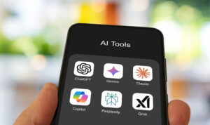 Smartphone showing an AI Tools folder with icons for ChatGPT, Gemini, Claude, Copilot, Perplexity, and Grok.