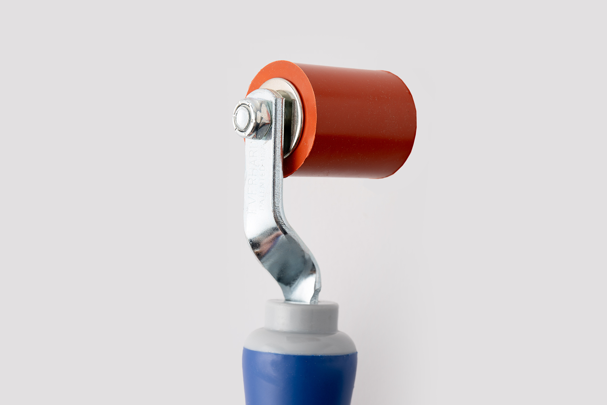 Close-up of red silicone roller with metal frame and blue ergonomic handle. Text reads'EVERHARD PATENTED U.S.A.'