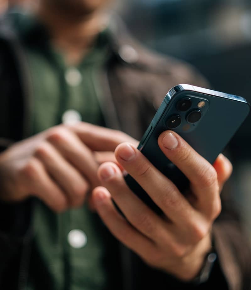 close up of hands holding onto a smart phone