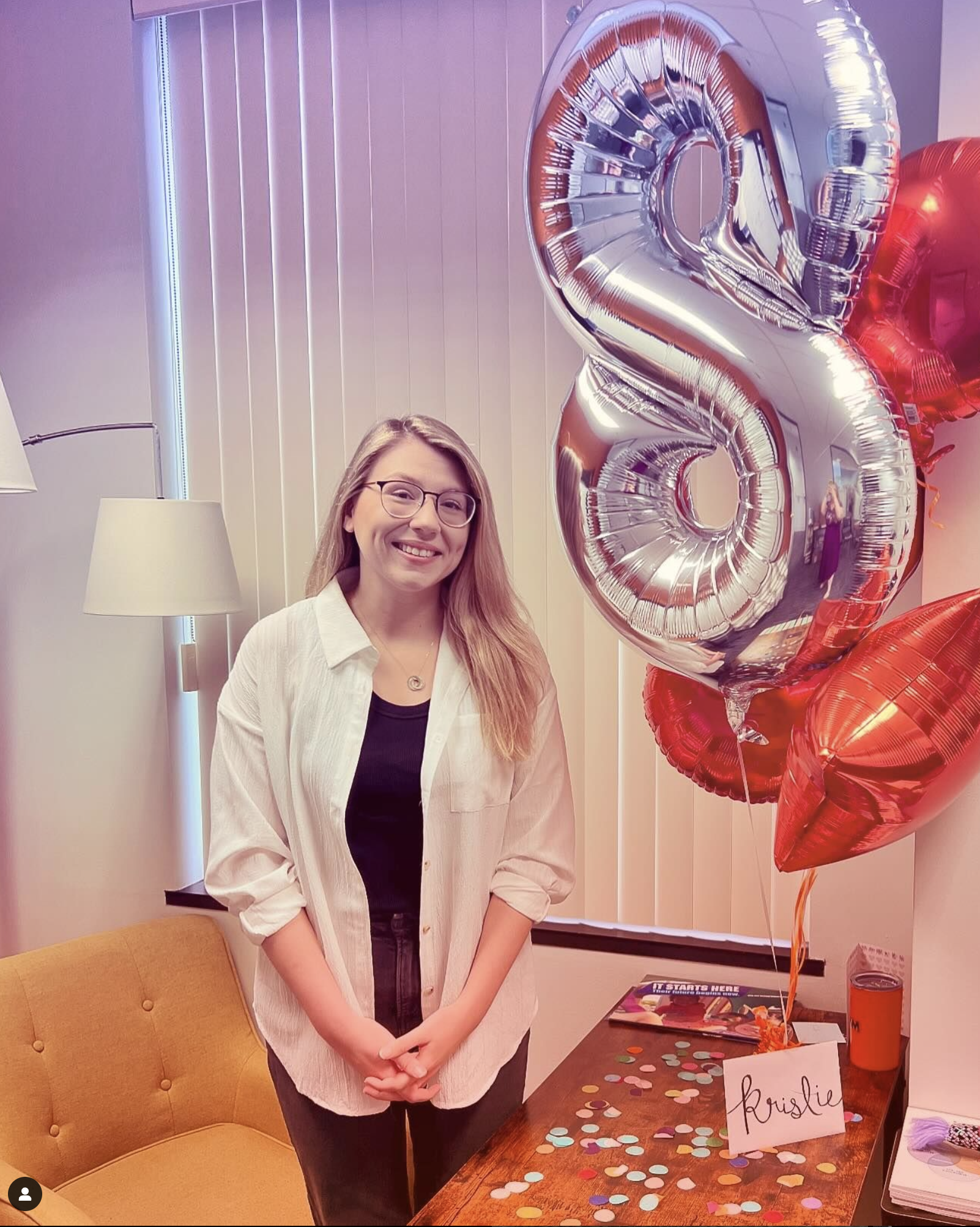 kristie-8-year-anniversary Kristie smiles with a silver 8 balloon and confetti, celebrating her 8-year work anniversary at FSM.
