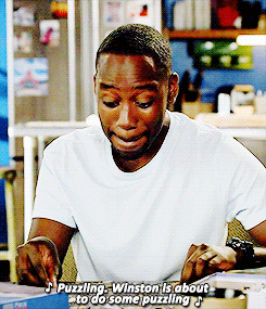 new girl singing GIF – FSM – Digital Marketing Agency Young man in a white T-shirt concentrating on a jigsaw puzzle at a table in a bright kitchen setting.